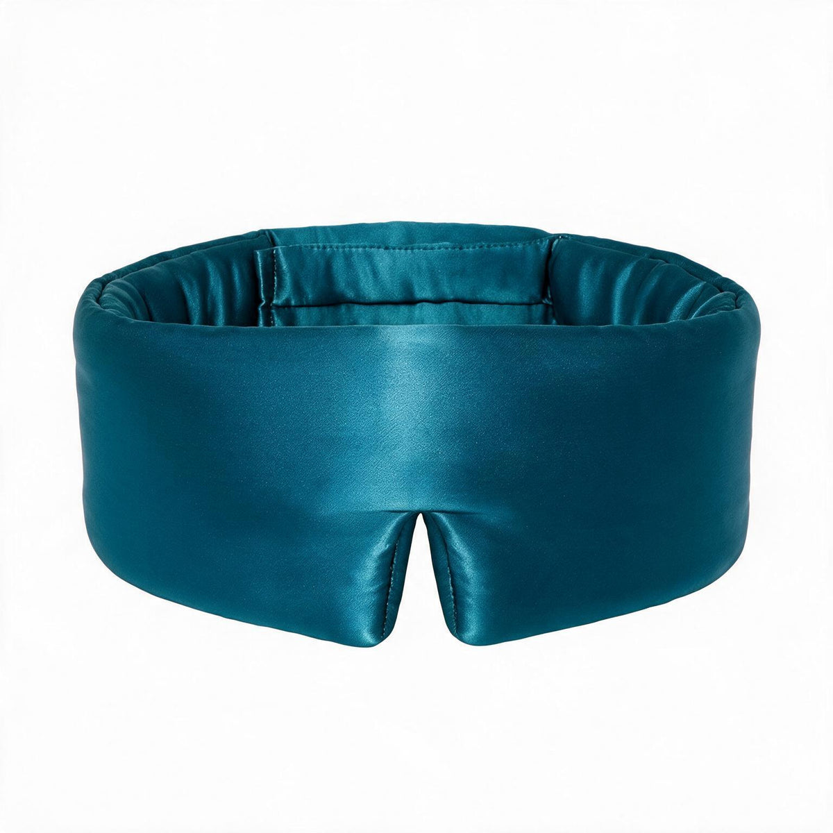 Lunia Reve mulberry silk sleep mask in Fathom worn in bed, showing the wide flat band around the head